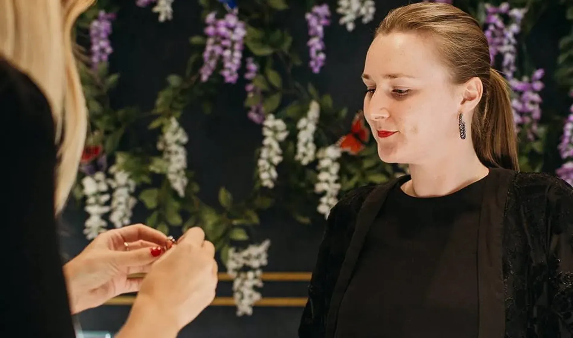 Stephen Einhorn assists a customer at her jewelry store in London.