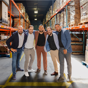 An image of the Transformer Table cofounders pictured in a warehouse.