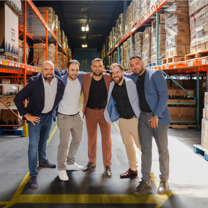 An image of the Transformer Table cofounders pictured in a warehouse.