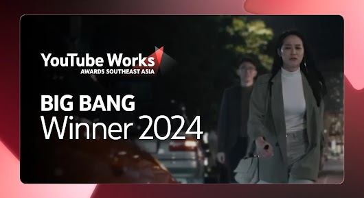 A woman in a blazer and shorts walks down a city street at night, with a blurred man following behind her; a red car is visible in the foreground. The image has a large overlay text that reads: "BIG BANG Winner 2024" next to the YouTube Works Awards Southeast Asia logo. A large play button is centered over the image, and a video player bar is visible at the bottom.