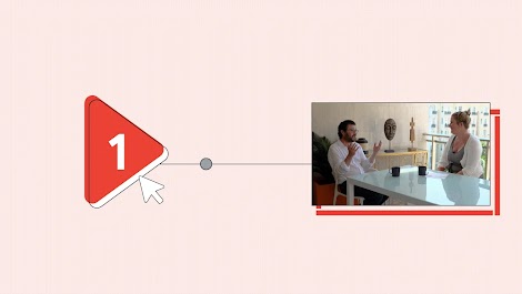 On the left, a life-size play button icon with a red overlay and a “1” on it. A cursor is next to it. The play button is connected by a line to a photograph of Nick Hulley and Jenni Baker sitting at a table, with two mugs between them, talking.