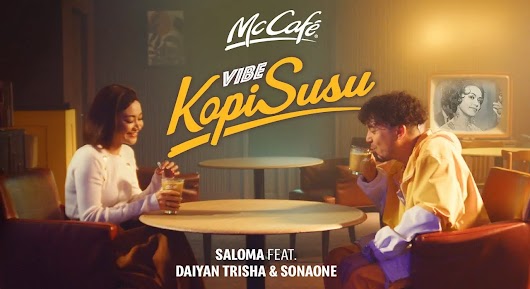 The video thumbnail depicts a vibrant, retro-style shot of musical artists, including SonaOne and Daiyan Trisha, sitting in a McCafé diner and enjoying their coffee, promoting the "Vibe Kopi Susu" song collaboration.