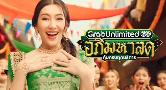 The video thumbnail shows a couple in a car looking delighted, with a collage of icons representing the various GrabUnlimited services like GrabFood and Grab transportation.