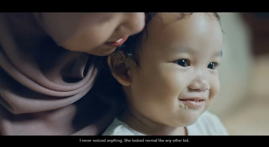 The video thumbnail depicts a testimonial-style shot of a concerned mother and her child with a healthcare professional, used to raise awareness about Iron Deficiency Anemia in children.