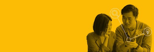 Two people perform a mobile search on a single device, with a magnifying glass and lightbulb icon coming out of it. Search automation solutions that help you drive growth.