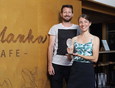 Zuzana Měřínská a Pavel Bechyně, majitelé kavárny Smetanka, stojí před stěnou s nápisem Kafe Smetanka a drží ocenění Křišťálový špendlík.