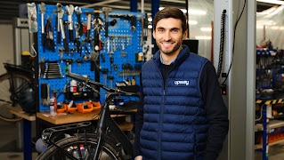 Upway Founder standing in a warehouse with bicycles.