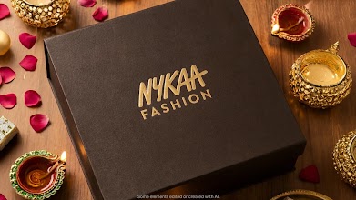 An elegant black and gold Nykaa Fashion gift box decorated with traditional lit diyas and rose petals.