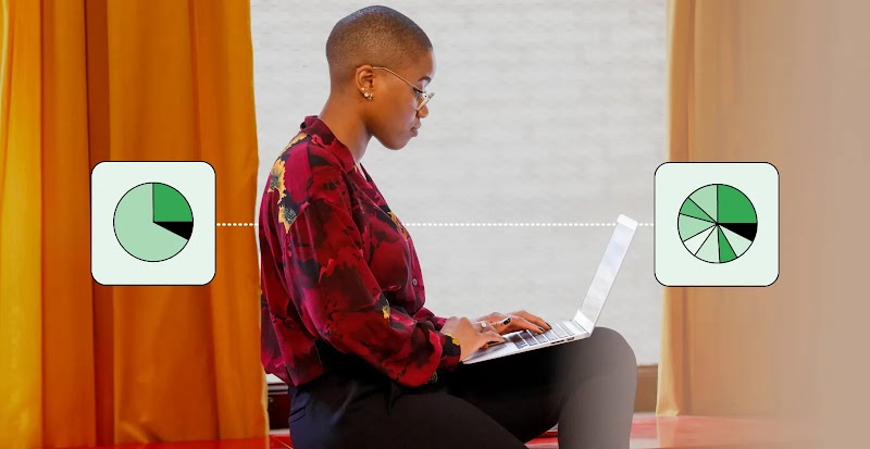 A woman with brown skin and very short hair, wearing glasses, a red and black blouse and black skirt, sits in profile, using a laptop. A pie chart with 3 pieces connects to her back with a fine line, and a pie chart with 9 pieces is connected to her front.