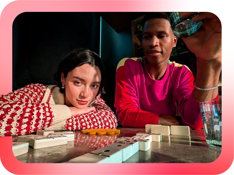 We see an image of a man and woman playing dominos