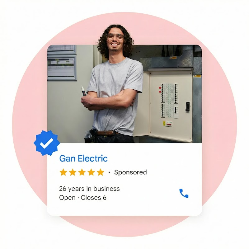 A local ad shows an electrician with long wavy hair standing next to a breaker  box.