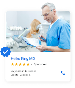 A local ad shows a dentist reviewing a chart near a patient in a chair.
