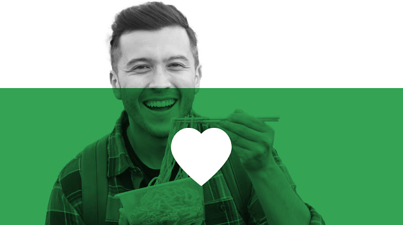 A Filipino man smiling and enjoying a bowl of noodles