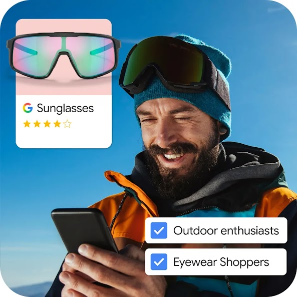 A composite graphic showing a man in an orange and black winter jacket and a blue beanie smiling while looking at his smartphone. He is wearing black ski goggles on his head. Overlaid on the image are two checked selection boxes labeled "Outdoor enthusiasts" and "Eyewear Shoppers". A product card in the upper left displays a pair of reflective, iridescent sports sunglasses with a Google logo, a 4-star rating, and the text "Sunglasses".