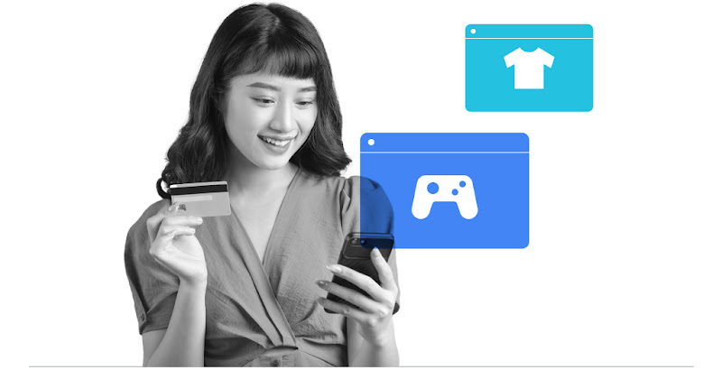 A Filipino woman holding a mobile phone in one hand and a credit card in another to make digital payment for online purchases