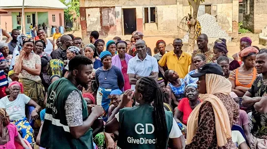 GiveDirectly Staff talking to a crowd of people