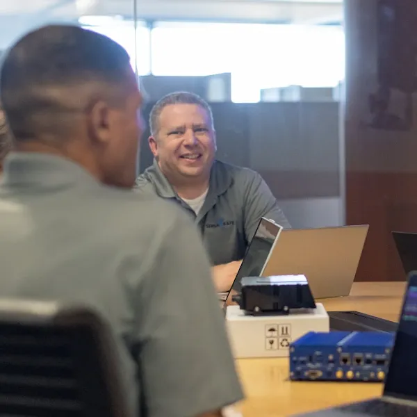 People sitting at table with computer