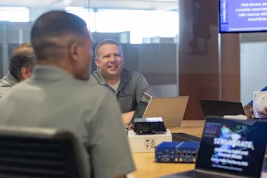 People sitting at table with computer