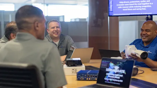 People sitting at table with computer