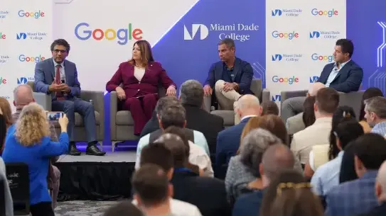 four people in chairs leading a panel discussion