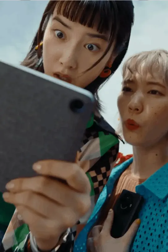 Group of people looking at a tablet screen. 