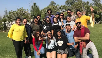 The Zyla team pose in daylight at a park.