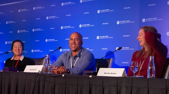 Google’s David Graff and Meta’s Monika Bickert laughing during a panel discussion at the TPI Aspen Forum.