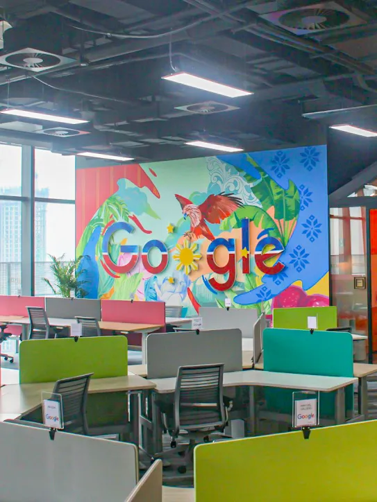 Um espaço de trabalho com o logotipo do Google e mesas diversas.
