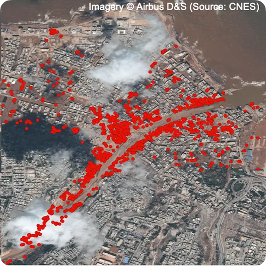 An aerial satellite view of a densely populated urban coastal area, overlaid with hundreds of red circular data points tracking a specific path through the city center. Text at the top credits the imagery to Airbus D&S and source CNES.