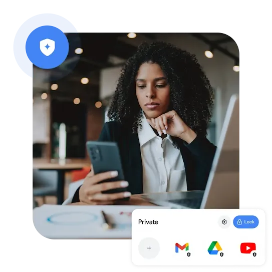 A person in an office setting wearing a black cardigan over a white button-up inquisitively looks at their phone.