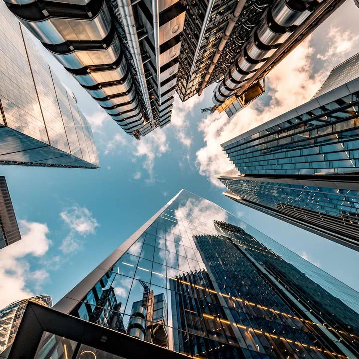 A view of city skyscrapers from a view at the bottom up.