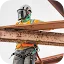 A construction worker wearing a safety harness, helmet, and full face shield stands on structural steel beams against a light sky.
