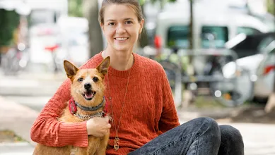 Dogo Founder, Rasa, and her dog, Ūdra, smile for the camera.