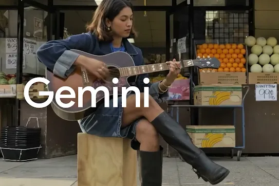A person plays a guitar in front of a fruit stand. A user interface appears, and the user types the command, "Edit the video to place me on clouds." The scene transforms, showing the person playing their guitar while sitting on a cloud in the sky.