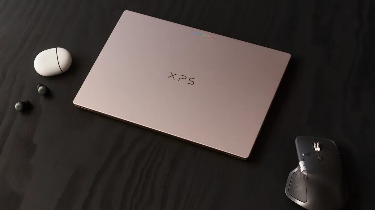 A Googlebook laid flat next to earbuds and a mouse