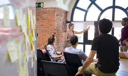 A man and woman watching on their laptops.