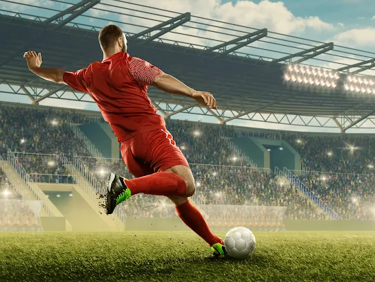 Man kicking a soccer ball.
