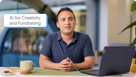 A man sitting at a desk with an open laptop, a coffee mug, and a notebook in an office setting. A blue text bubble in the upper left corner reads "AI for Creativity and Fundraising."