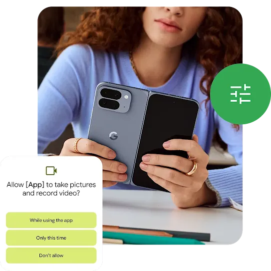 A person sitting at a desk is looking at their Moonstone Pixel 10 Pro Fold. A green filter icon and an “Allow app” notification are both around the border of the image.   