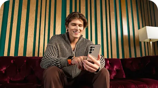 Man sitting holding Android phone