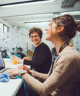 A woman sits on a chair.