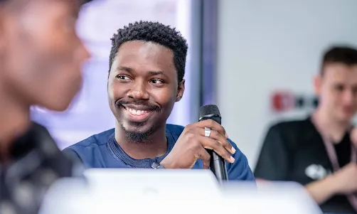 A man holding mike while smiling