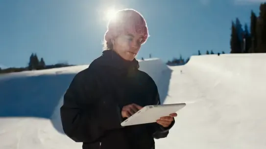 Snowboarder reviews data on a tablet