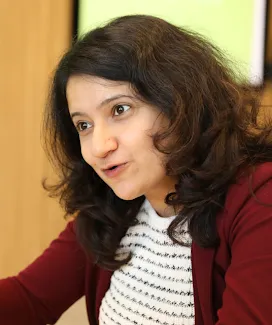 A woman wear red jacket.