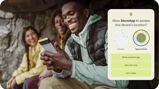 An image of a group of friends sitting in the rocky outdoors with one person looking at their Android phone.  A graphic overlay seeking permission to allow an app approximate or precise location access is placed close to the image. Additional permission options include allowing access while using the app, only this time or don’t allow.