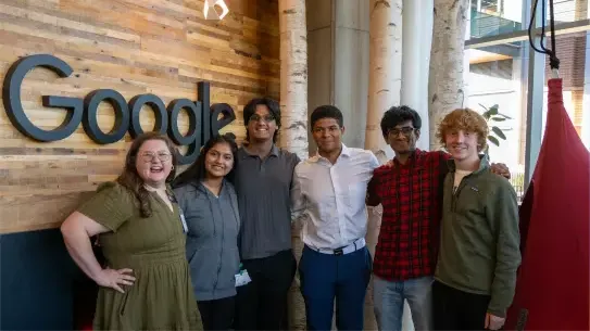 six students in front of a Google sign