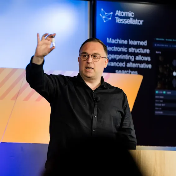 A person hosting an event and standing at a podium.