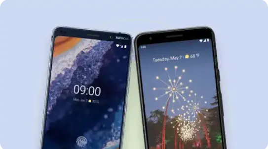 Two smartphones placed side-by-side on a flat surface: a Nokia 9 PureView on the left displaying a lock screen with a fingerprint icon and clock, and a Google Pixel device on the right displaying a live wallpaper with fireworks.