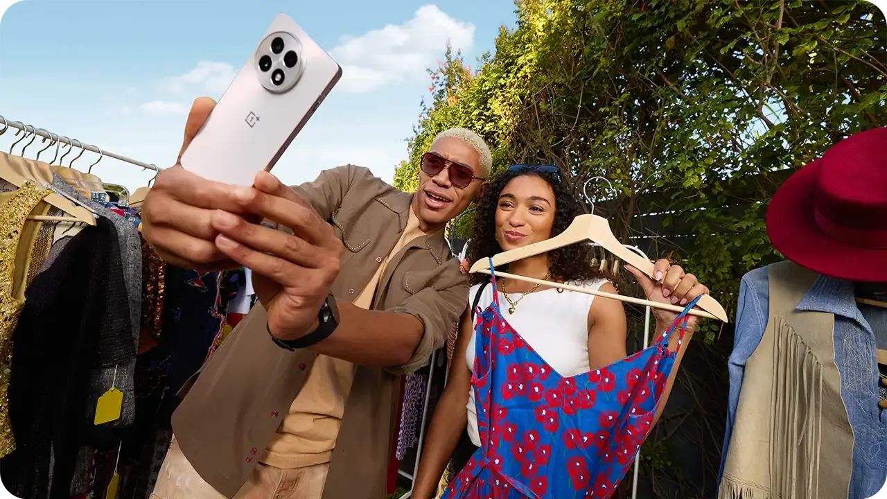 Man and woman taking a selfie while shopping for clothes.