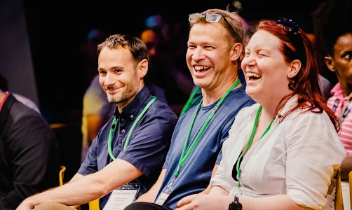 A group of people laughing while sitting.